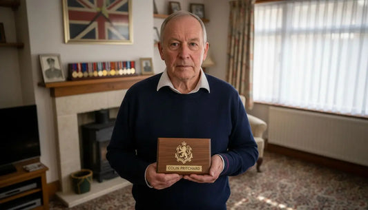 Veteran holding engraved military plaque at home