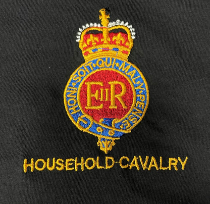 Household Cavalry embroidered crest on a black fabric background, featuring a crown above a red, gold, and blue circular emblem with the letters E.R.